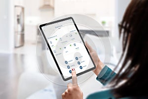 Woman use smart home automatization app for monitoring and control home devices concept photo