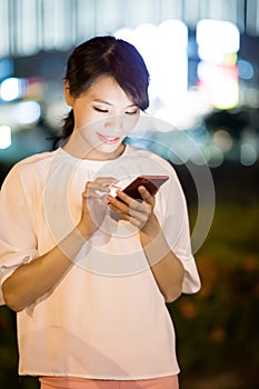 Woman use smart phone at night