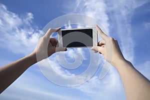 Woman use smart phone take a photo of blue sky and beautiful cloud , isolate black monitor