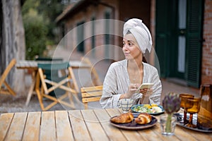Woman use smartphone and have breakfast at morning