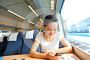 Woman use smartphone interior of train