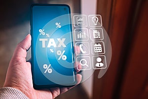 Woman use smartphone to calculate tax reduction.