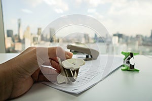 Woman use staple puller to remove staple from business document