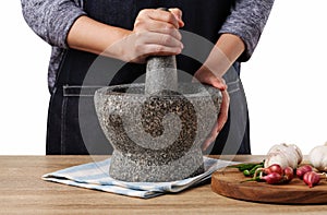 Woman use stone Mortar and Pestle for cooking green curry paste