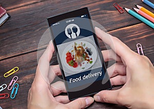 The woman uses the app on the mobile to order food delivery.