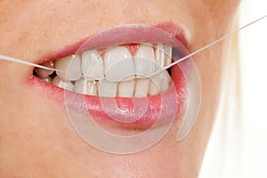 Woman uses dental floss