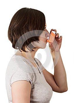 Woman uses device for inhalation isolated on white