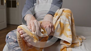 A woman uses a foot towel in front of the pedicure. The nails take on a fresh and neat appearance during the pedicure