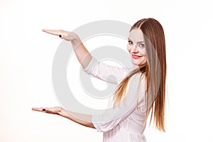 Woman uses hands to indicate area of frame, copy space for product