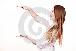 Woman uses hands to indicate area of frame, copy space for product