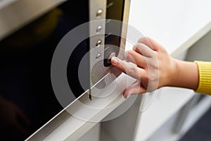 Woman uses a microwave oven