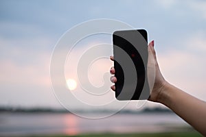 Woman uses she Mobile Phone outdoor, close up