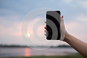 Woman uses she Mobile Phone outdoor, close up