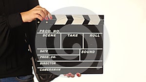 Woman uses movie production clapper board, on