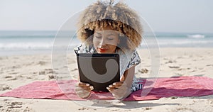 Woman Uses A Tablet On The Beach