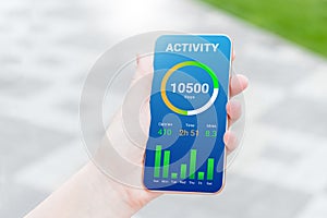 woman using activity tracking app on mobile phone