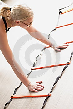 Woman using agility ladder