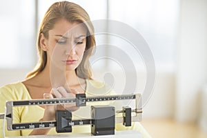 Woman Using Balance Weight Scale At Gym