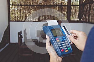 Woman using bank terminal for credit card payment