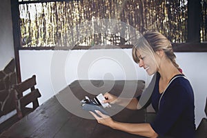 Woman using bank terminal for credit card payment