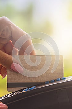 Woman using bank terminal for credit card payment