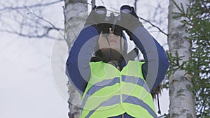 Woman using binoculars for bird watching