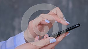 Woman using black smartphone with touchscreen display - close up side view