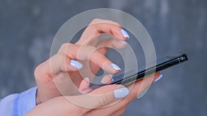 Woman using black smartphone with touchscreen display - close up side view