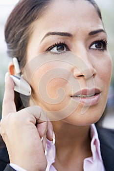 Woman using bluetooth earpiece