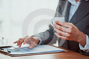 Woman using calculator on her desk