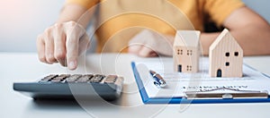 Woman using calculator during signing home contract documents. Contract agreement, real estate,  buy and sale and insurance