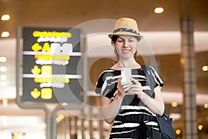 Woman using cell phone in airport