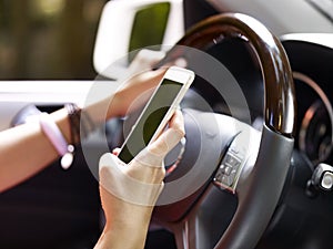 Woman using cellphone while driving