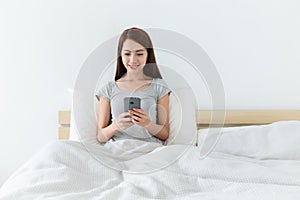 Woman using cellphone in living room