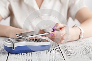 Woman using cellphone pay by NFC