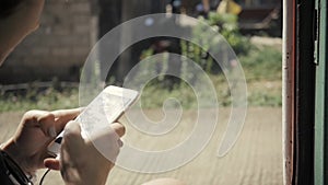 Woman using cellphone phone inside old asia train