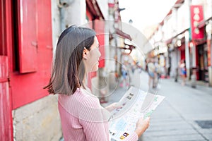 Woman using city map in Macao photo