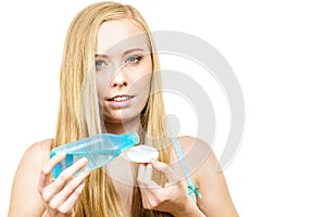 Woman using cleanser cosmetic