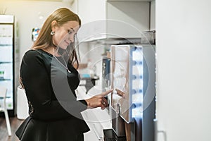 A woman using a coffee machine maker