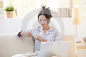 Woman using computer at breakfast