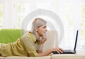 Woman using computer at home