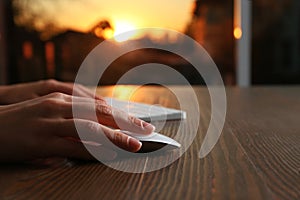 Woman using computer mouse and keyboard at table