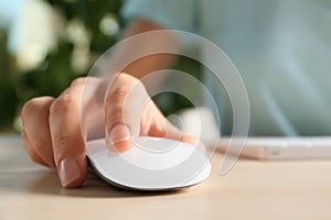 Woman using computer mouse at table