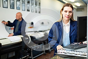 Woman using computer in printing office