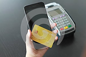 A woman using credit card on smartphone  for buy products in the shop. Concept of spending via credit card on line shopping