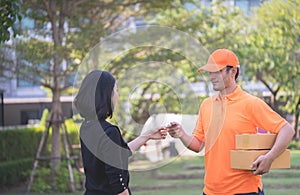 Woman using credit card to pay for online delivery