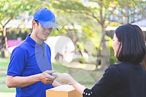 Woman using credit card to pay for online delivery