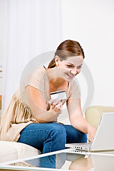 Woman using creditcard to buy internet merchandise