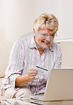 Woman using creditcard to buy internet merchandise