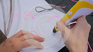 Woman using 3D printing pen